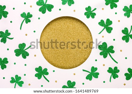 Shiny St. Patricks Day background. Golden round hole and shiny green shamrocks pattern. Happy St.Patricks Day background.