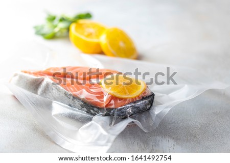 Salmon fillets in a vacuum package. Sous-vide, new technology cuisine. Selective focus, copy space Royalty-Free Stock Photo #1641492754