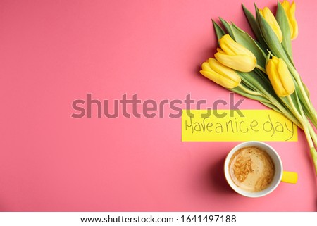 Aromatic morning coffee, beautiful flowers and card with HAVE A NICE DAY wish on pink background, flat lay. Space for text