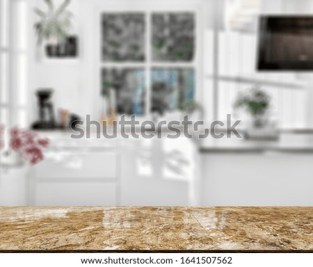 Stone table top and blurred kitchen interior background