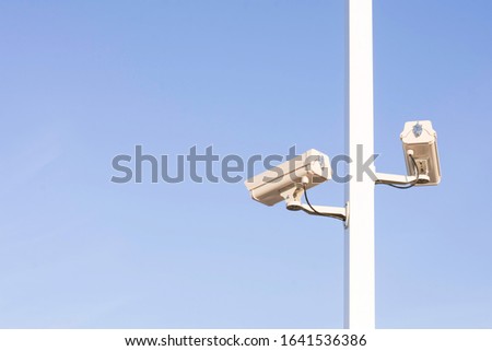 Closeup of traffic security camera on blue sky, Camera surveillance monitoring (CCTV)
