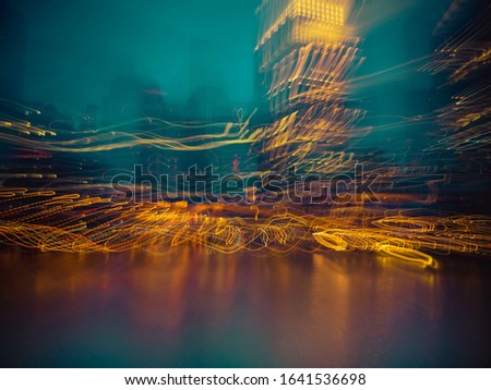 Abstract Action Night Citysacpe of Free Floating Light Trails Dancing over the Sea Water on Turquoise Color Pastel Sky Background