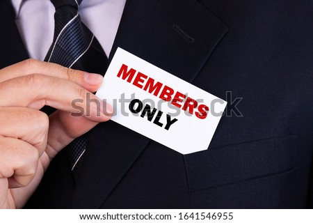Businessman puts a card with text MEMBERS ONLY in his pocket