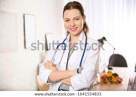 Professional nutritionist with stethoscope in her office
