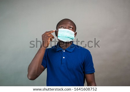 young black man wearing a medical face mask