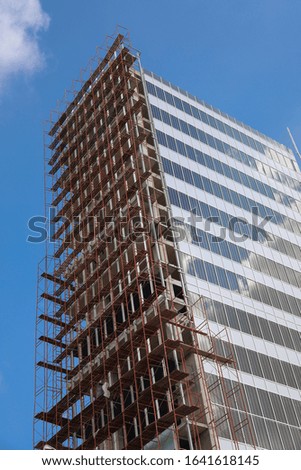 Large high rise building under construction, sky and cloud background