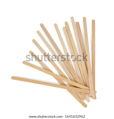 Wooden stirrers for coffee, tea and drinks, laid out in random order, isolated on a white background. Royalty-Free Stock Photo #1641632962