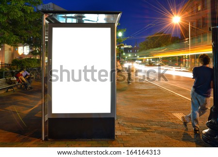 Bus Shelter Billboard at Night Royalty-Free Stock Photo #164164313
