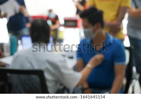 Royalty high quality free stock abstract blur and defocused photo of a doctor examining and collecting information about people who are likely to be infected with the corona virus.