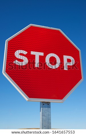 Stop traffic sign with clear blue sky.