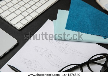 Composition with sketches and accessories on black stone table, closeup. Designer's workplace