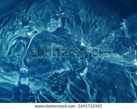 The​ abstract​ of surface blue​ water​ in​ the​ deep​ sea​ for​ background. Blue water​ texture​ for​ background​