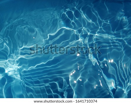 The​ abstract​ of surface blue​ water​ in​ the​ deep​ sea​ for​ background. Blue water​ texture​ for​ background​