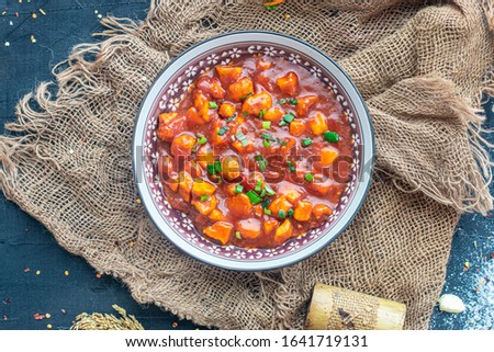 Stock image of Chinese Chicken Manchurian on a dark table 