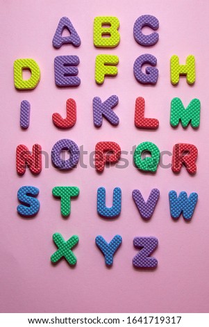 Colorful plastic englisch alphabet letters on pink background