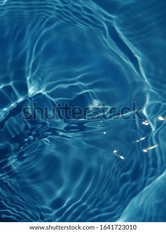 The pattern​ of metal​ texture​ of​ surface​ blue​ water​ in​ the​ deep​ sea​ for​ background. Blue​ water​ texture​ for​ background​