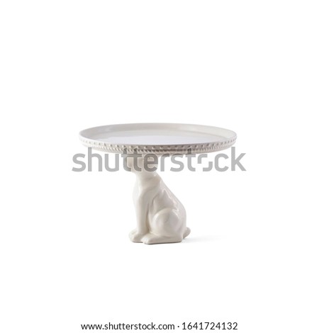 Still life photography of a decorative white porcelain cake stand in the shape of a rabbit 