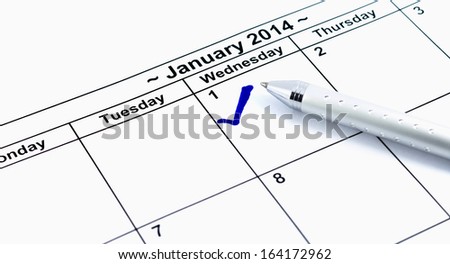 Blue check. Mark on the calendar at 1St January 2014 with pen, new year's day