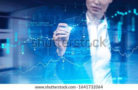 Unrecognizable businesswoman working with futuristic financial chart interface in blurry office. Concept of GUI and market analysis. Toned image double exposure