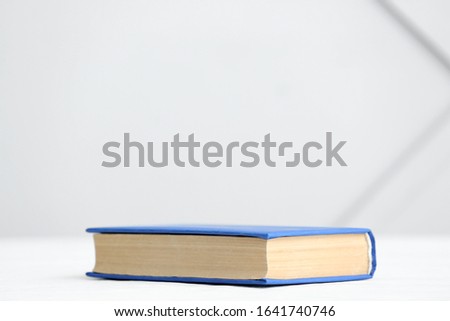 Book on table against light background