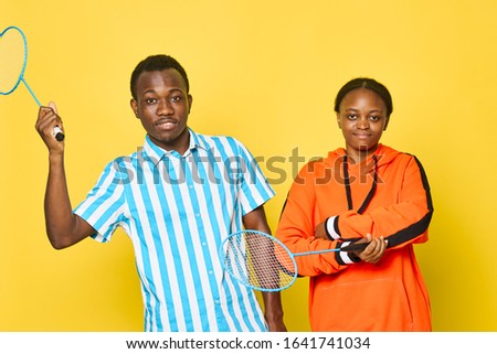 Young people on a yellow background African appearance family friends
