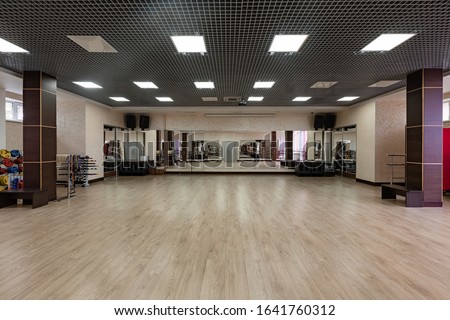 large and light hall with mirrors, music, equipment for dancing, sports. Group fitness room. Modern interior design. Fitness workout. Fitness gym background. Gym equipment background. Empty space.