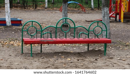 bench on the playground autumn fallen leaves