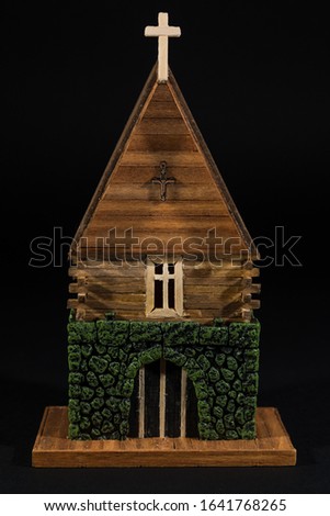Old western church. Miniature western old town handcrafted from wood with an black background.