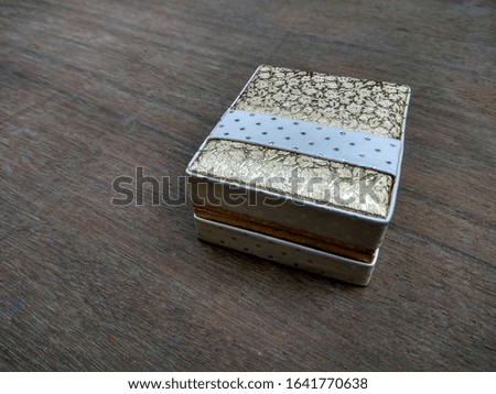 Elegant box to keep ring jewelry. Wooden backgound