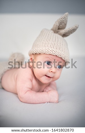 Baby two months old in a knitted hat