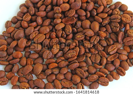 Roasted coffee beans pile isolated on white background. From top view