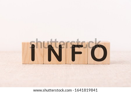Info word concept written on wooden cubes on a light table and light background