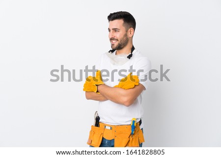 Craftsmen or electrician man over isolated white background looking to the side