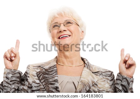 An old woman pointing up with fingers. Isolated on white. 