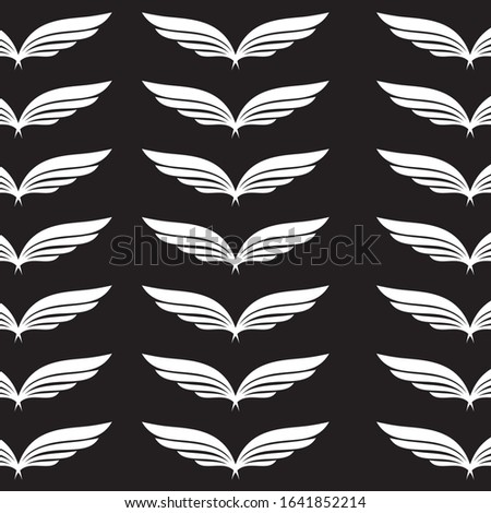white color angel wings on a black background