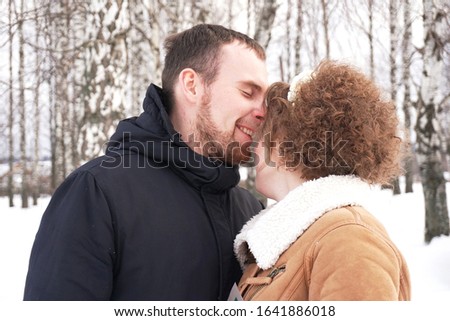 married couple in winter in a birch grove