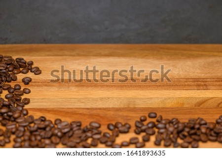Coffee beans on dark wood with copy space