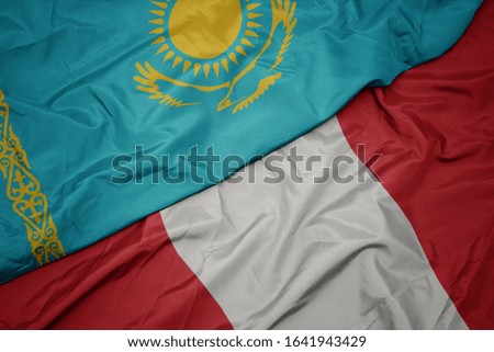 waving colorful flag of peru and national flag of kazakhstan. macro