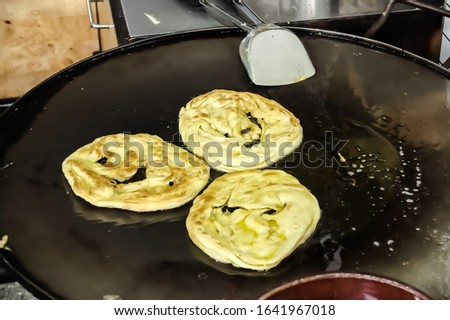 Fried Roti on hot pan with boiling oil