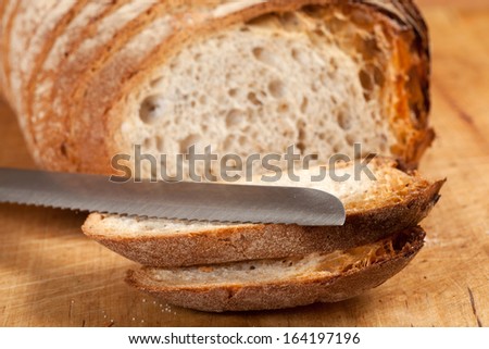 Sliced bread on a wooden board.