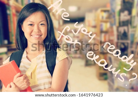 Smiling female student with book in hands