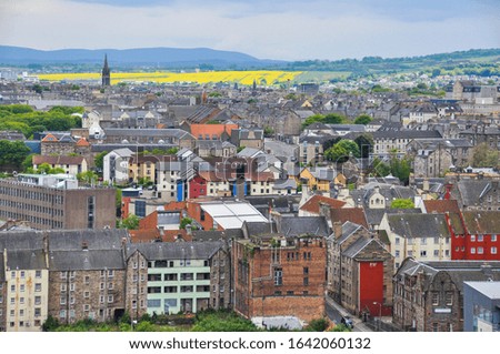 Beautiful landscape picture taken from Calton Hill looking down on Edinburgh City with its colourful houses and yellow fields