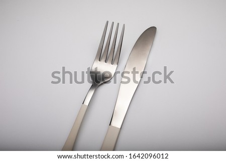 knife and fork on white background shining