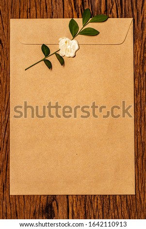 The words "with love" wax-seal stamp on brown envelope with old brown background wood. Concept for valentine.