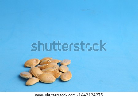 pumpkin seeds on color background