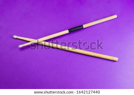 A pair of wooden drumsticks isolated on color background. copy space