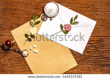 The words "with love" wax-seal stamp on brown and white envelopes with old brown background wood. Concept for valentine.