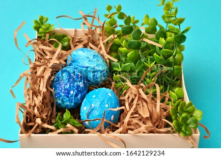 Spring Easter colorful painted eggs on the blue background flat lay closeup top view beautiful picture. Congratulations card happy holiday
