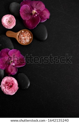 Top view of spa theme objects on black background. wellness layout frame with orchid. Elegant and luxury spa.