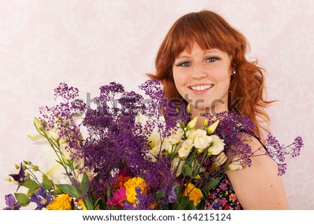 Portrait of woman in interior with colorful bouquet flowers